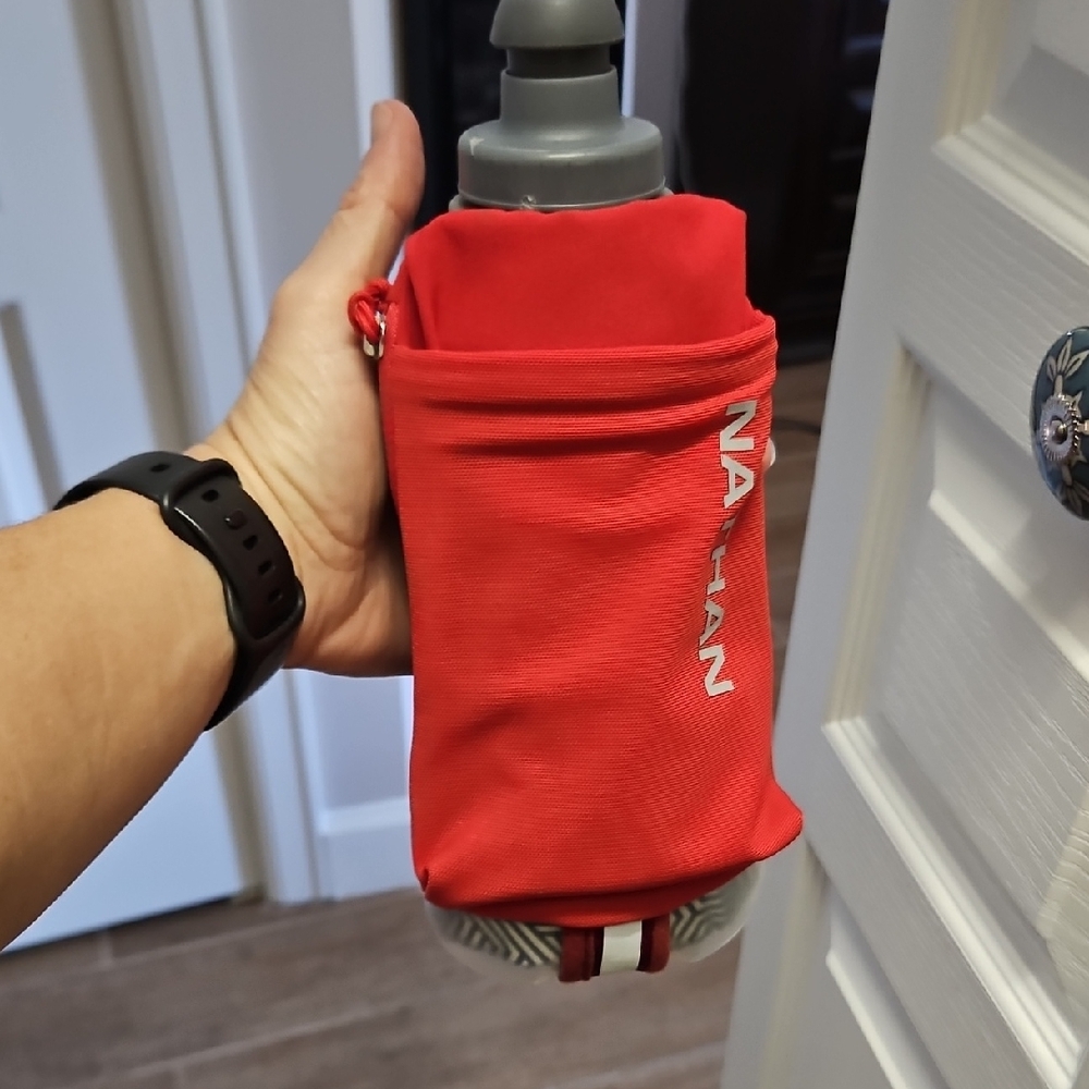 Nathan Red Handheld Running Bottle with Pocket. Holds 18oz